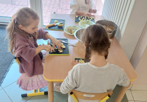 dziewczynki kroją warzywa